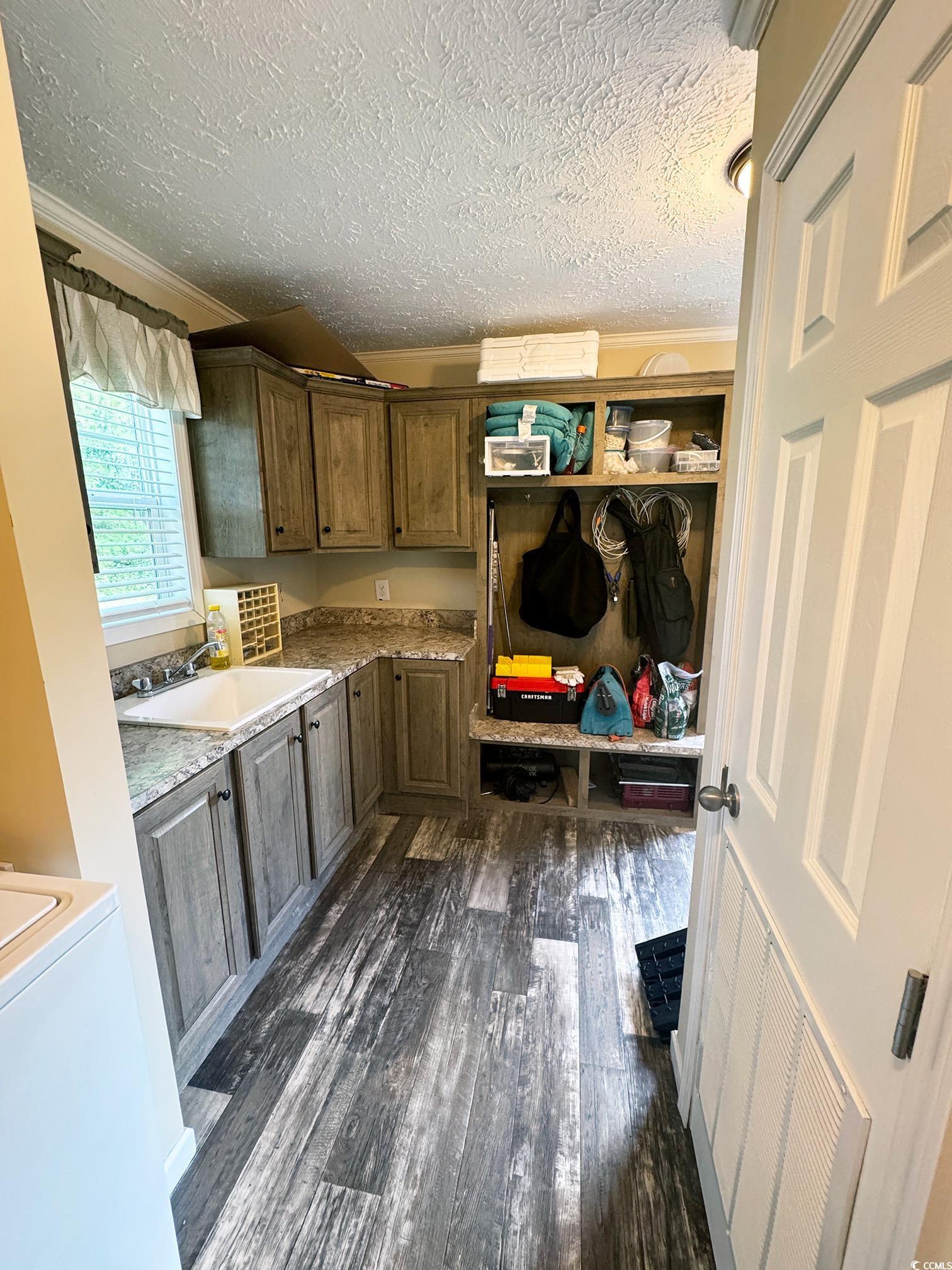 2620 Red Bluff Road Loris, SC 29569 - Photo 31 of 33 Washroom with cabinet space, dark wood-style floor