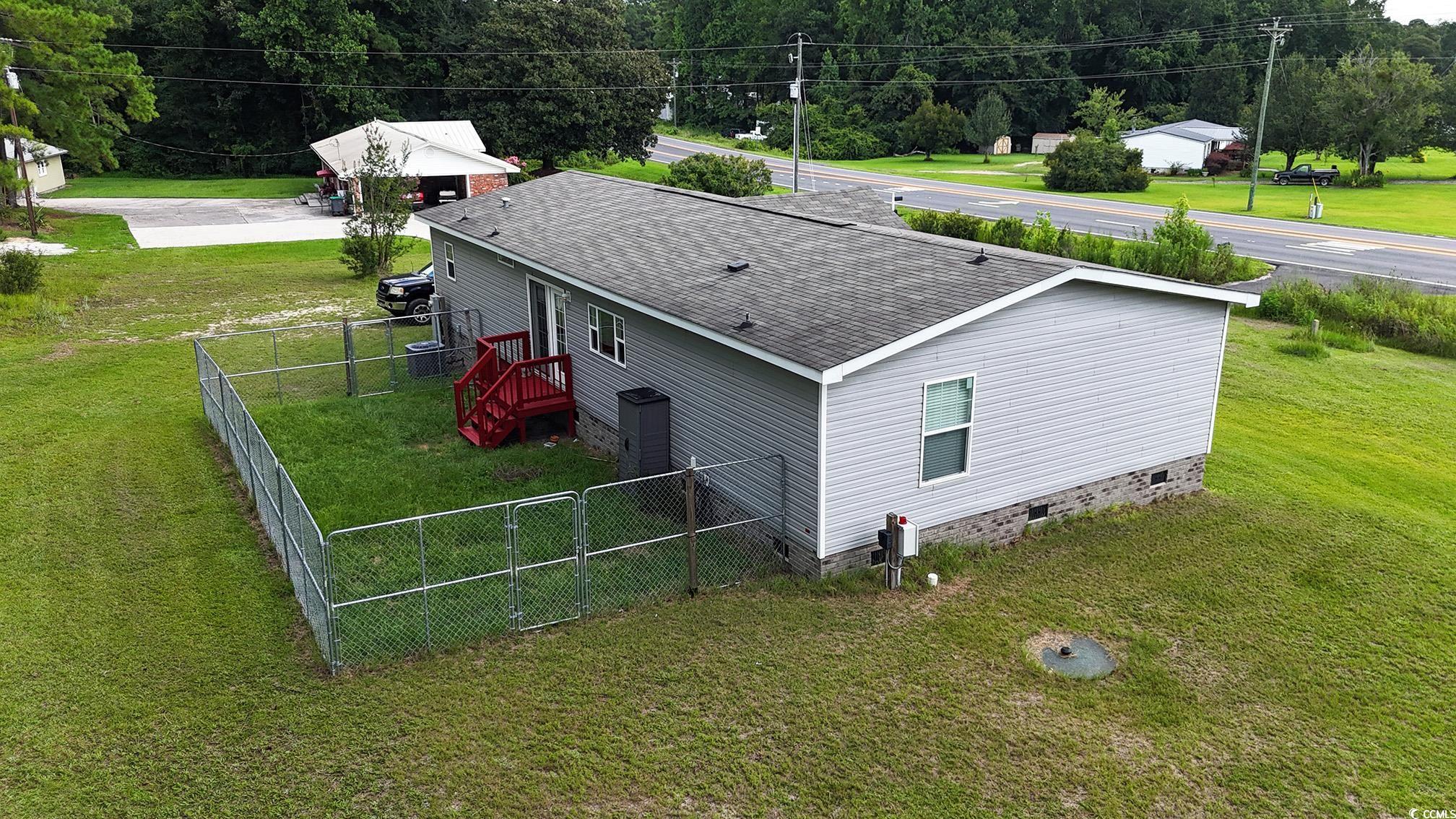 2620 Red Bluff Road Loris, SC 29569 - Photo 5 of 33 View of property exterior featuring roof with shin