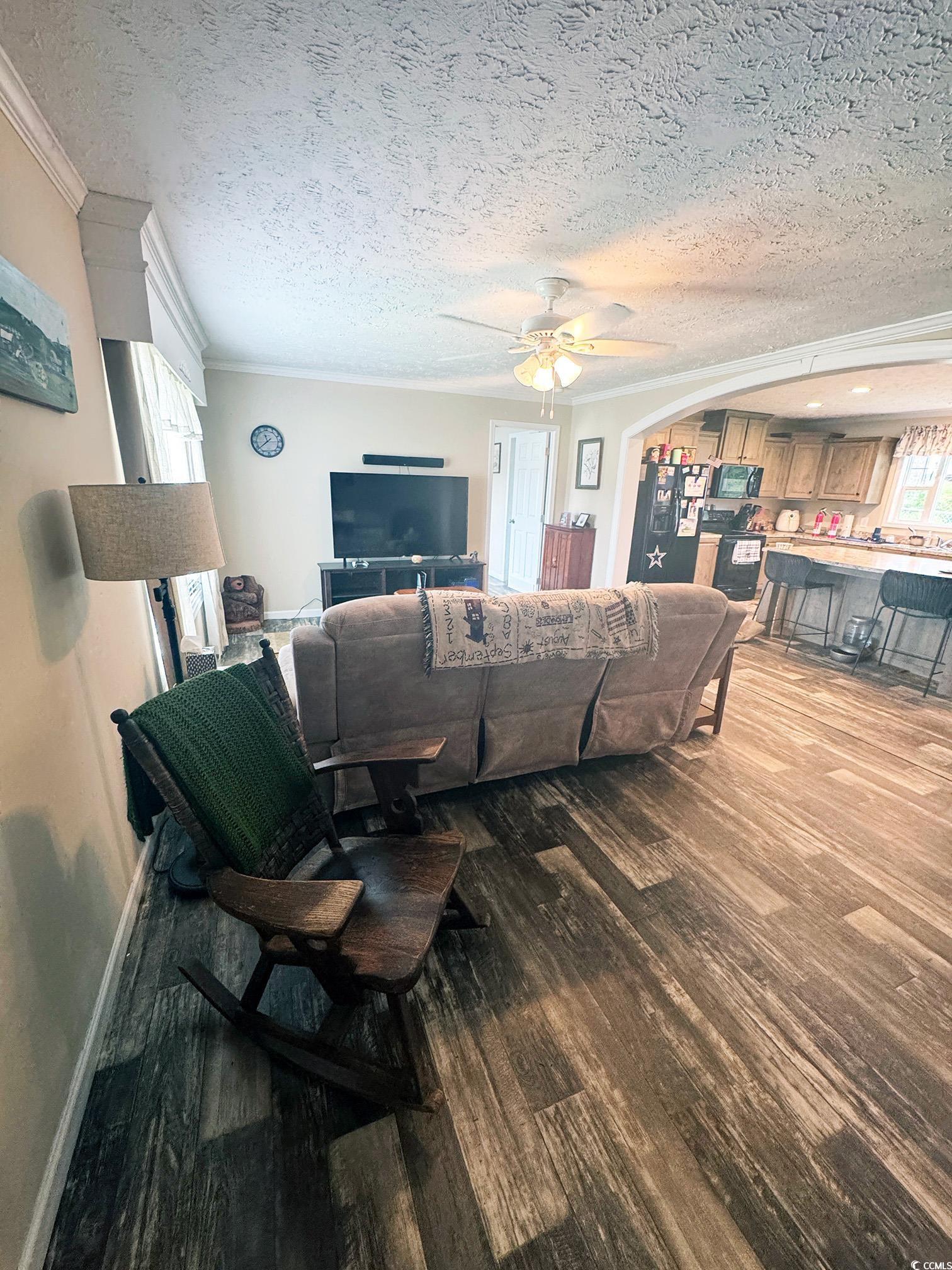 2620 Red Bluff Road Loris, SC 29569 - Photo 9 of 33 Living room with crown molding, wood finished floo