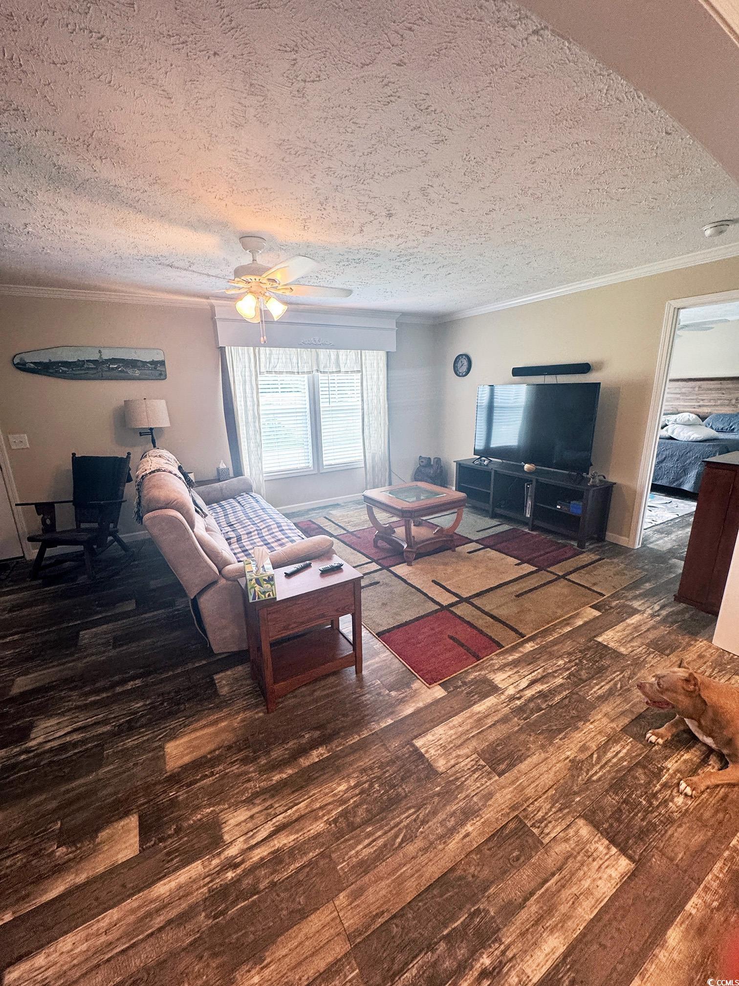 2620 Red Bluff Road Loris, SC 29569 - Photo 10 of 33 Living room with ornamental molding, wood finished