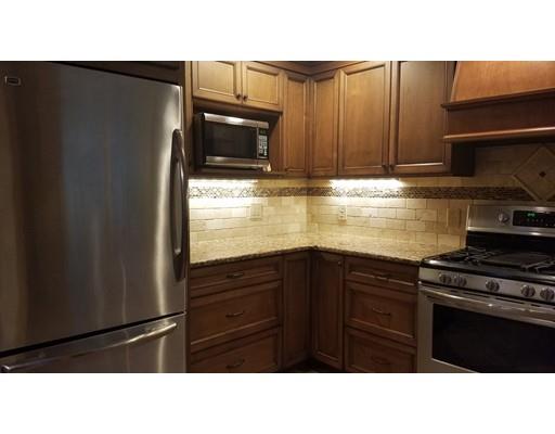 374 Grand Valley Road Springfield, MA 01128 - Photo 12 of 28 a kitchen with a refrigerator stove and cabinets