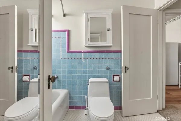 a white toilet sitting next to a bathroom sink