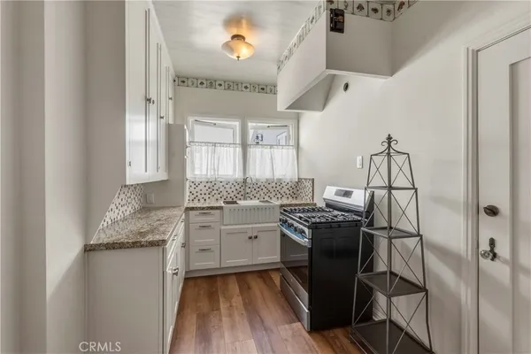 a kitchen with a sink appliances and cabinets
