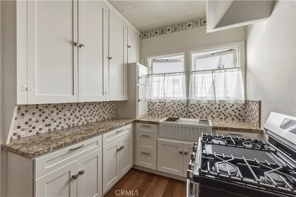 a kitchen with stainless steel appliances granite countertop a stove and a sink