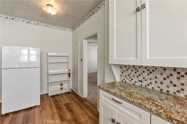 a kitchen with granite countertop a sink and a stove