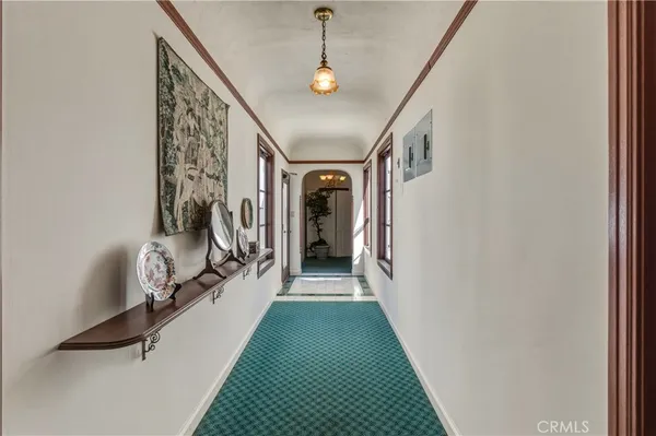 a view of a hallway with a white walls and stairs