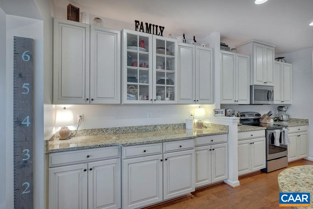 2346 Jersey Pine Ridge Charlottesville, VA 22911 - Photo 13 of 45 a kitchen with stainless steel appliances granite countertop a sink and cabinets with wooden floor