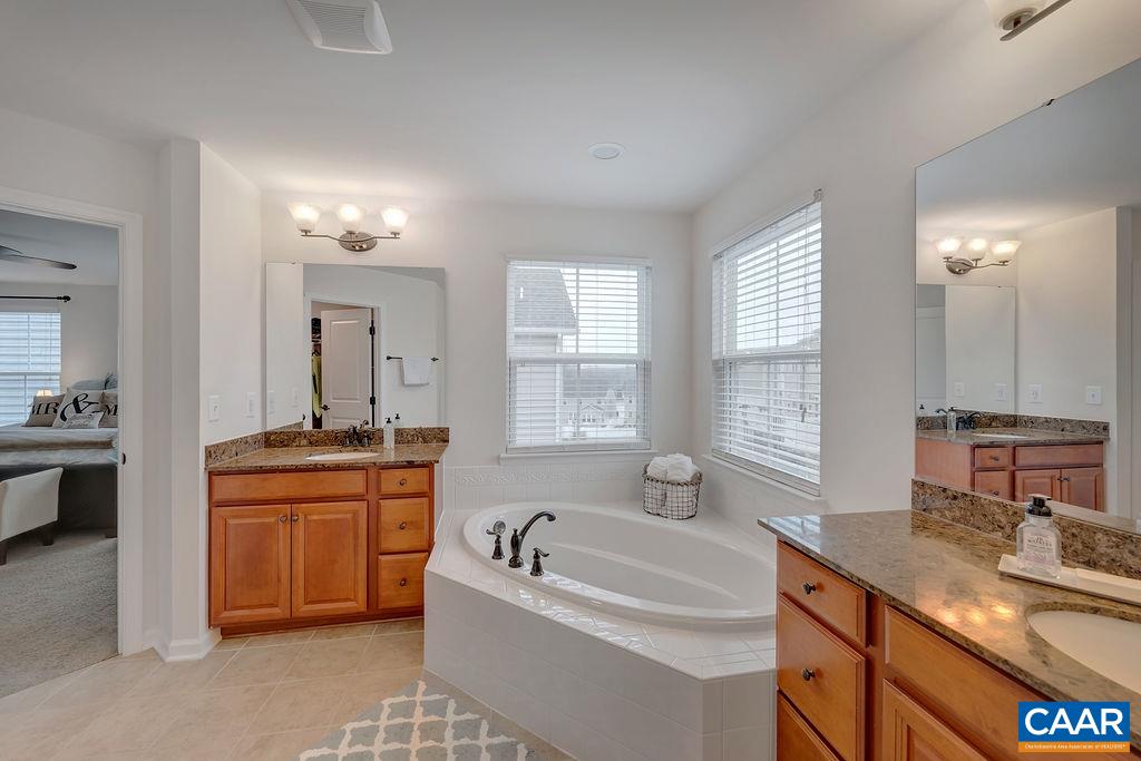 2346 Jersey Pine Ridge Charlottesville, VA 22911 - Photo 33 of 45 a spacious bathroom with a granite countertop tub sink and mirror