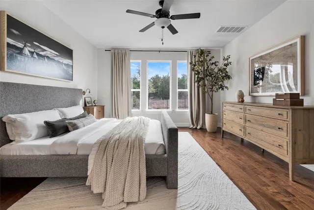 a bedroom with a large bed and a chandelier