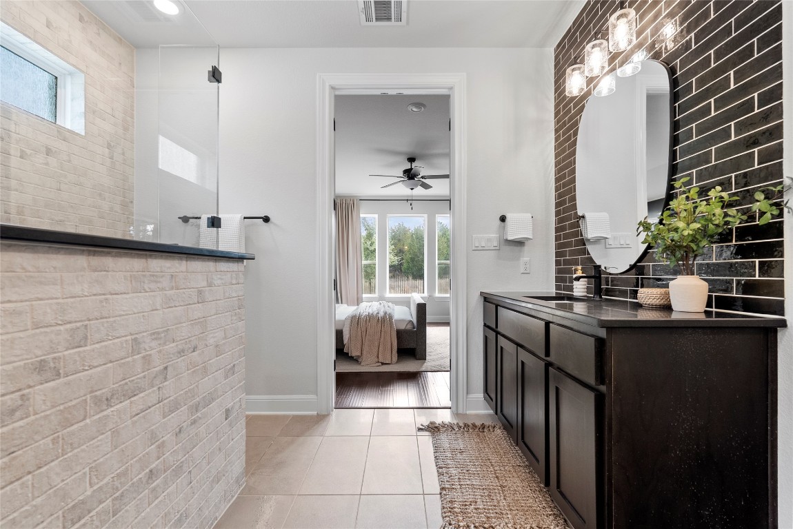 177 Running Bird Road Austin, TX 78737 - Photo 25 of 40 a bathroom with a sink and a mirror