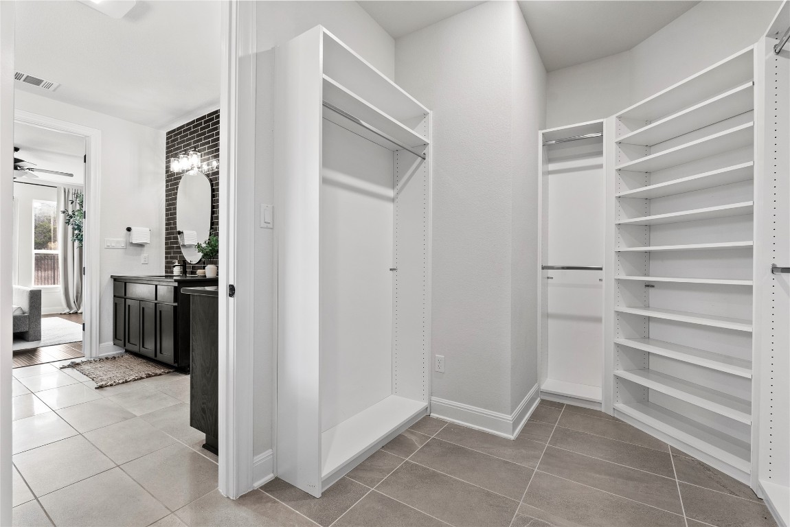 177 Running Bird Road Austin, TX 78737 - Photo 27 of 40 a view of walk in closet with empty racks