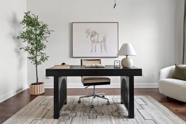 a living room with furniture and a potted plant