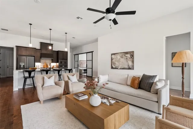 a living room with furniture and a wooden floor