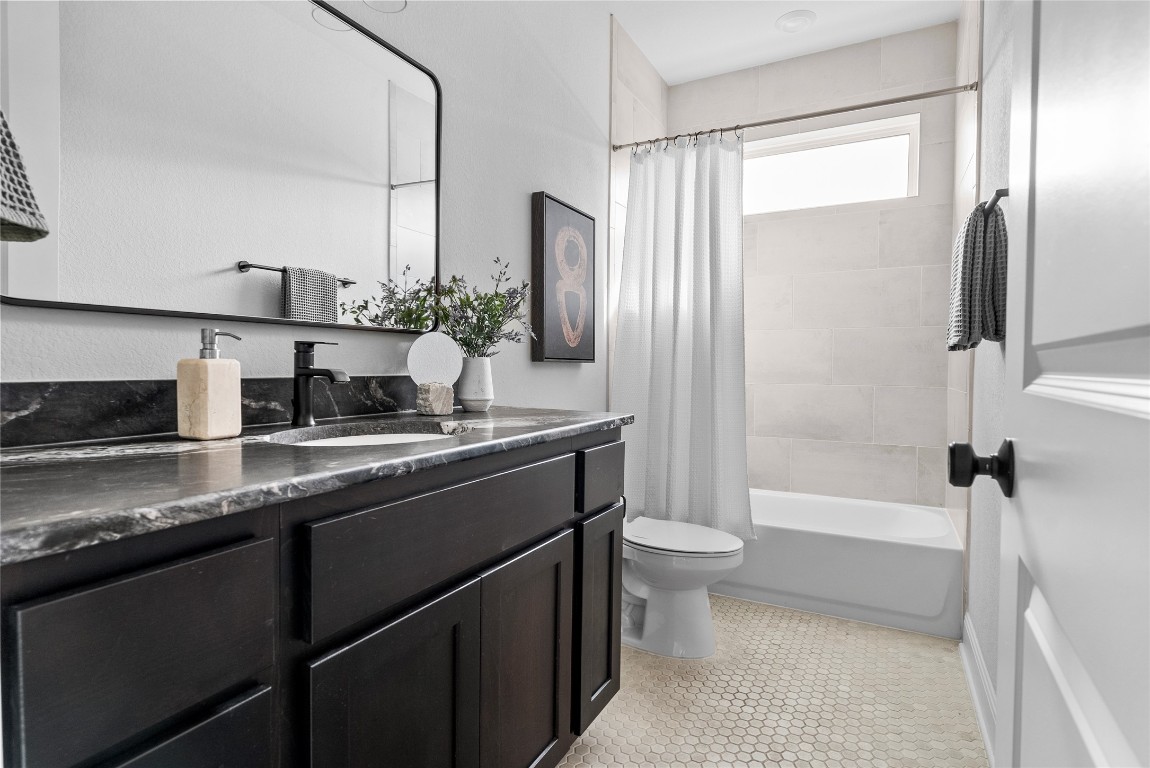 177 Running Bird Road Austin, TX 78737 - Photo 35 of 40 a bathroom with a double vanity sink toilet and shower