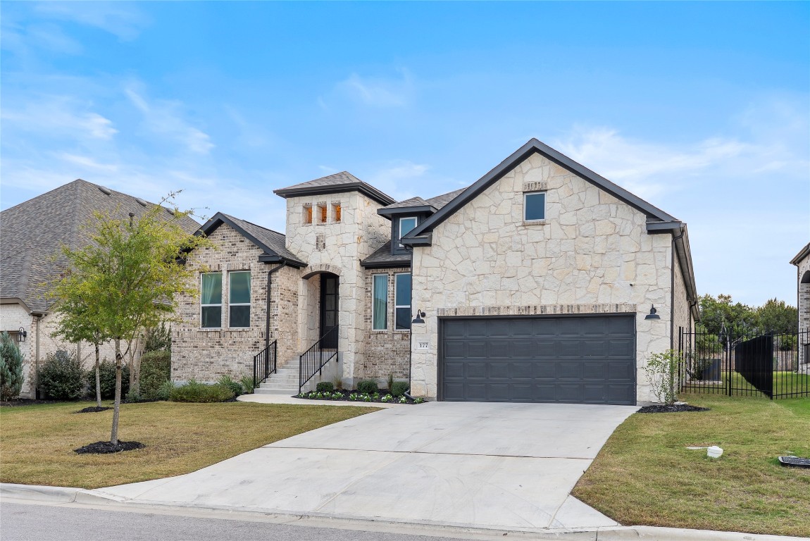 177 Running Bird Road Austin, TX 78737 - Photo 40 of 40 a front view of a house with a garden