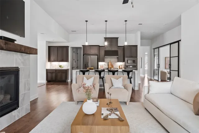 a living room with kitchen island furniture and a fireplace
