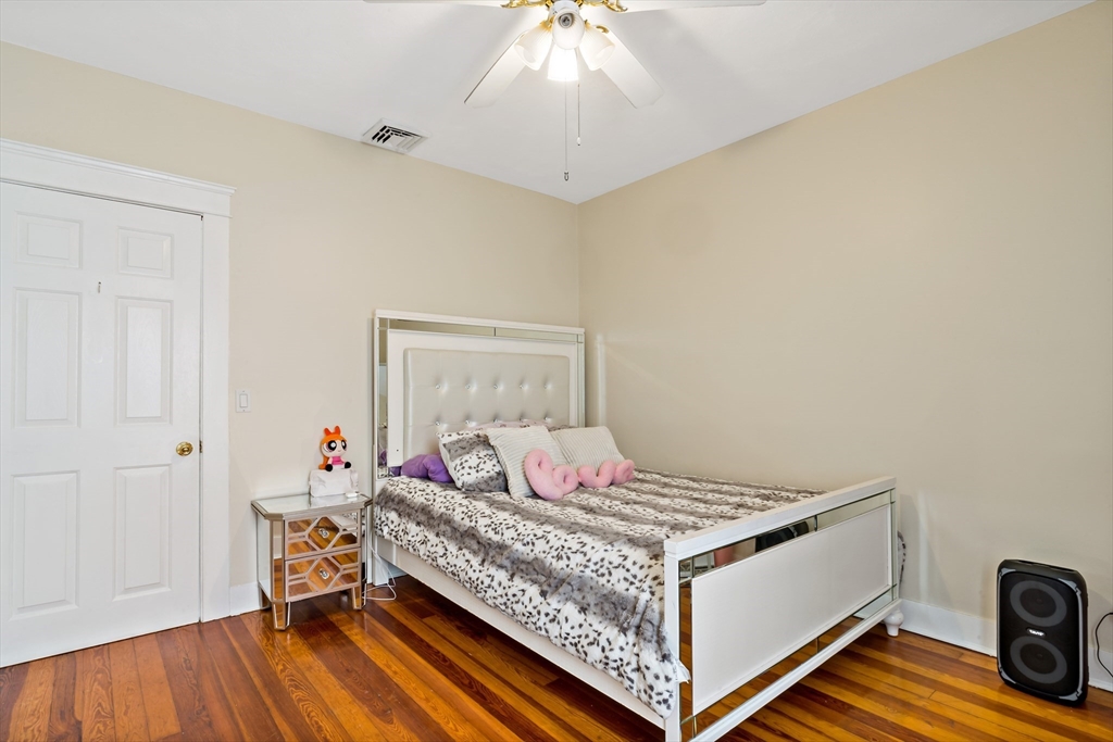 1000 Riverside Avenue Somerset, MA 02726 - Photo 20 of 26 a bedroom with a bed and wooden floor