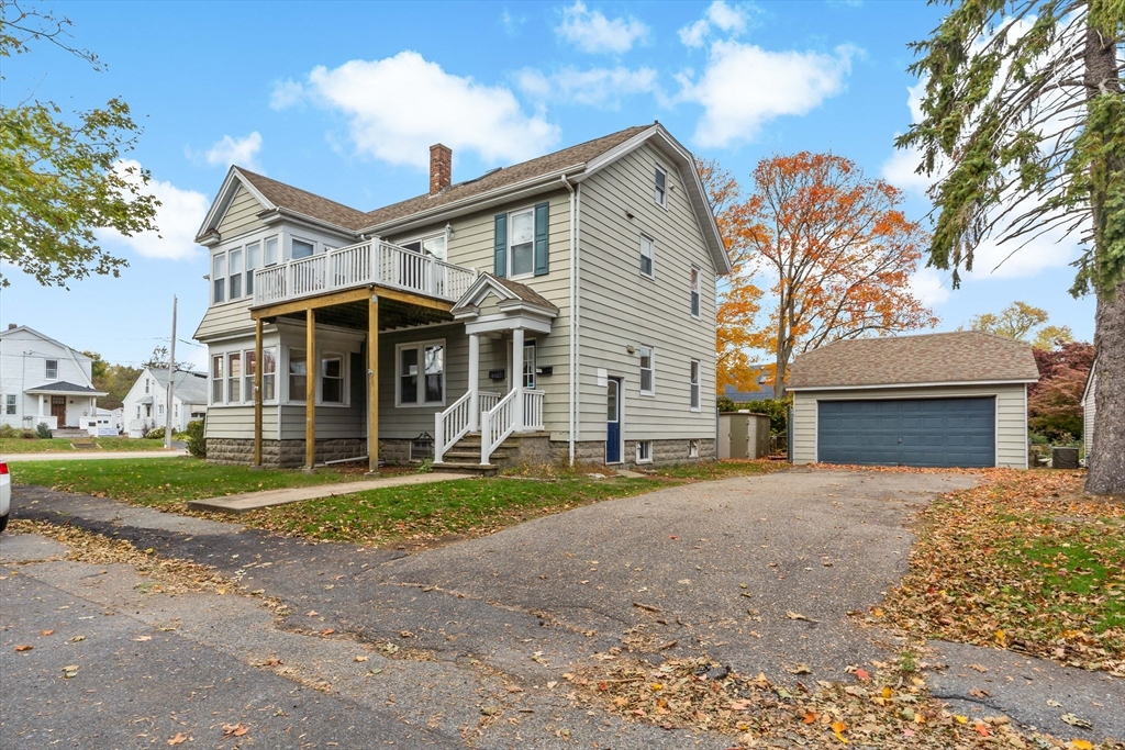 1000 Riverside Avenue Somerset, MA 02726 - Photo 2 of 26 a front view of a house with a yard and garage