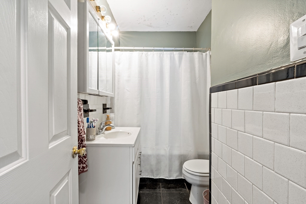 1000 Riverside Avenue Somerset, MA 02726 - Photo 24 of 26 a bathroom with a sink a toilet and shower curtain