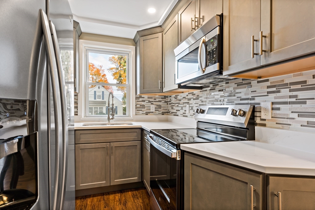 1000 Riverside Avenue Somerset, MA 02726 - Photo 5 of 26 a kitchen with stainless steel appliances a sink stove and cabinets