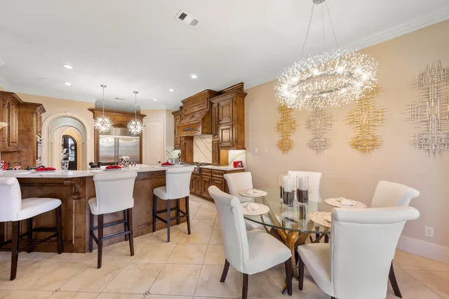 a view of a dining room with furniture and chandelier