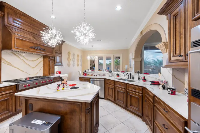 a kitchen with a sink a stove and cabinets
