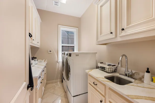 a spacious bedroom with a bed and a chandelier