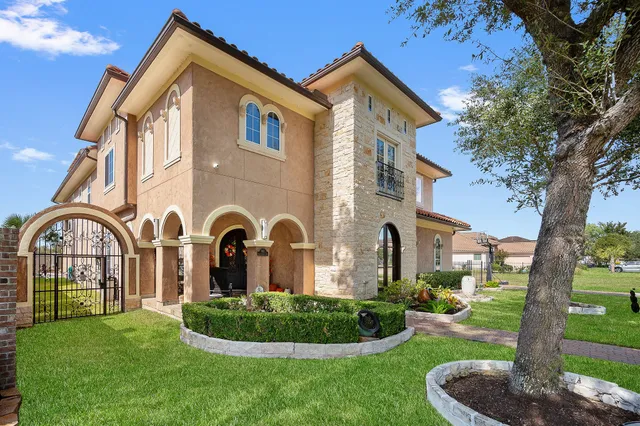 a front view of a house with a garden
