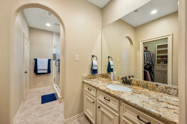 a bedroom with a bed dresser and a flat tv screen