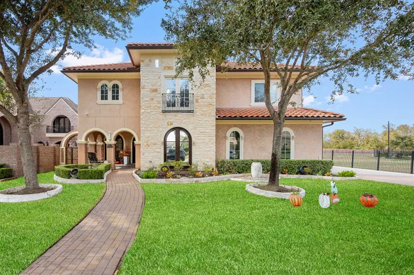 a front view of house with yard and green space