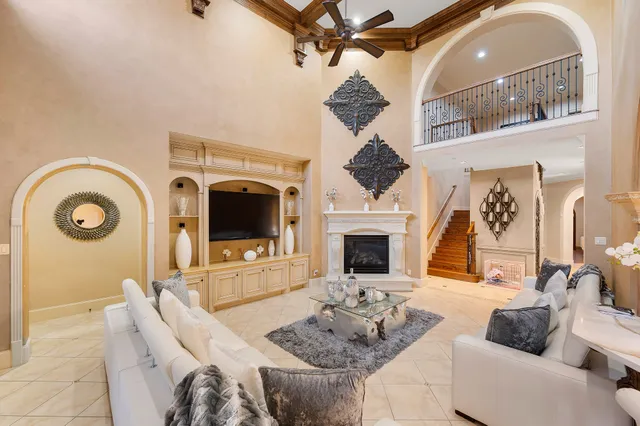 a bedroom with a large bed and a chandelier