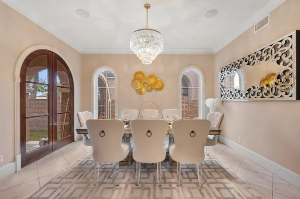 a view of a dining room with furniture and chandelier