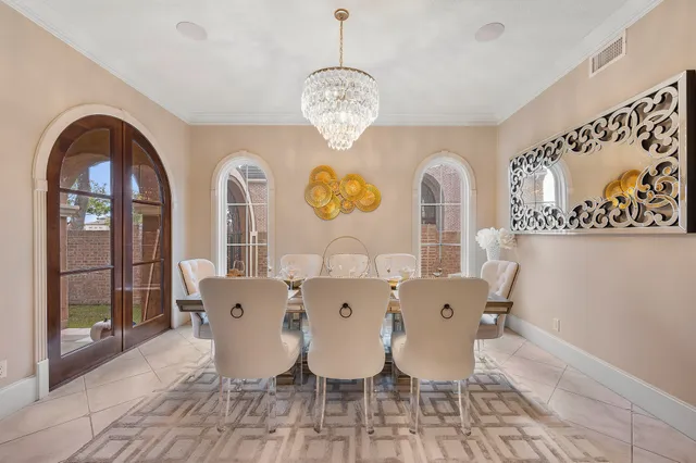 a view of a dining room with furniture and chandelier