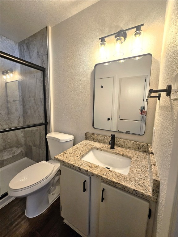 4816 Delwood Street, Unit 3 Corpus Christi, TX 78413 - Photo 13 of 19 a bathroom with a granite countertop toilet sink and mirror