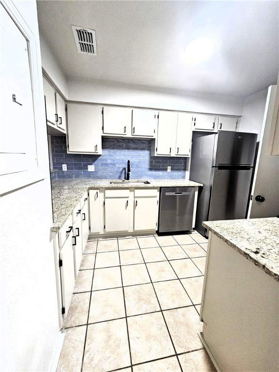 4816 Delwood Street, Unit 3 Corpus Christi, TX 78413 - Photo 7 of 19 a kitchen with stainless steel appliances a sink a counter top space and cabinets