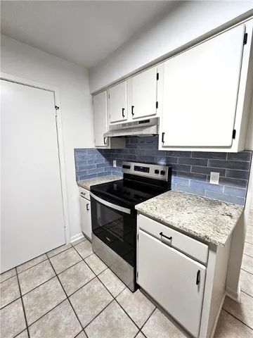 a kitchen with a stove and a sink