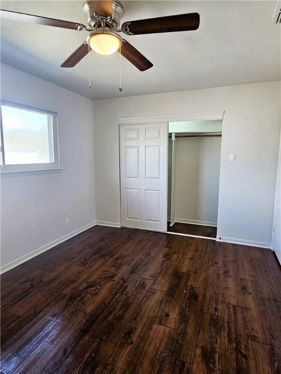 4816 Delwood Street, Unit 3 Corpus Christi, TX 78413 - Photo 10 of 19 a view of an empty room with chandelier fan and wooden floor