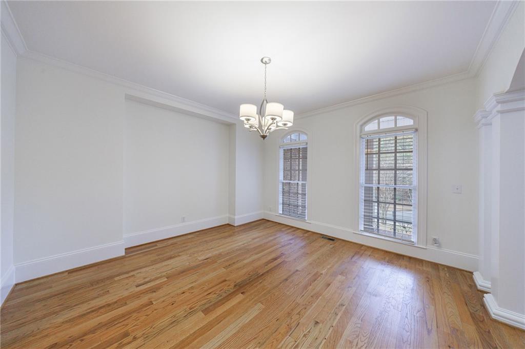 125 River N Circle Sandy Springs, GA 30328 - Photo 16 of 96 a view of an empty room with wooden floor and a window
