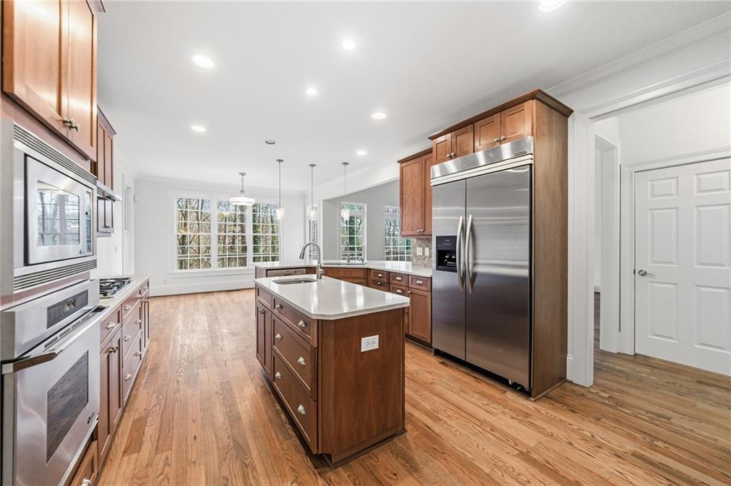 125 River N Circle Sandy Springs, GA 30328 - Photo 19 of 96 a kitchen with stainless steel appliances granite countertop a refrigerator a sink and wooden floor