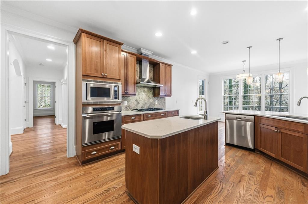 125 River N Circle Sandy Springs, GA 30328 - Photo 27 of 96 a kitchen with stainless steel appliances granite countertop a sink stove and oven