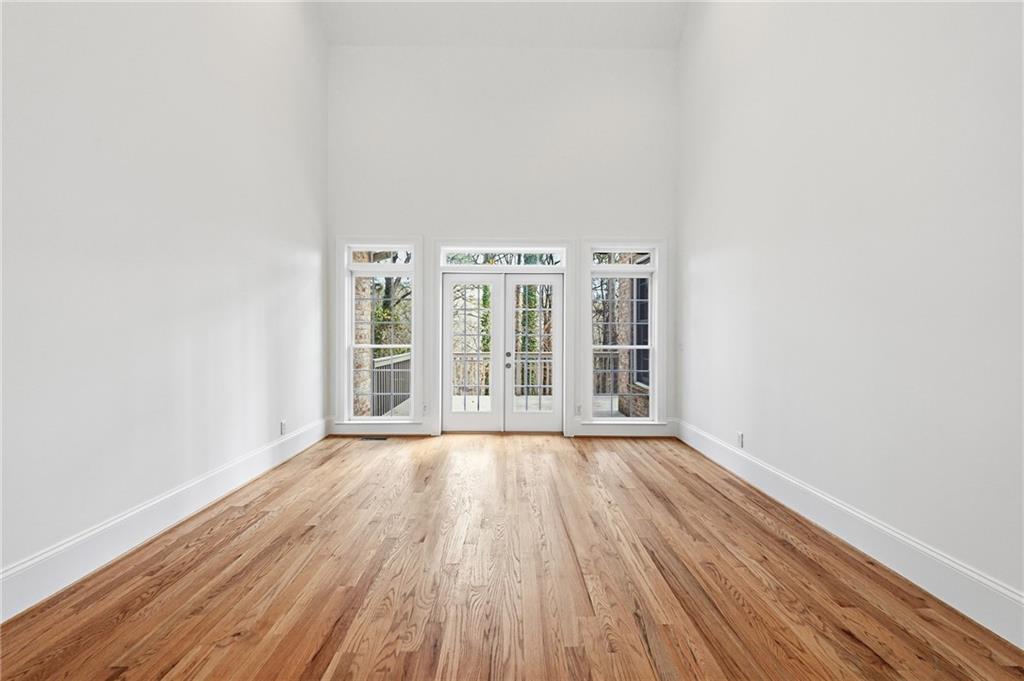 125 River N Circle Sandy Springs, GA 30328 - Photo 40 of 96 an empty room with wooden floor and windows