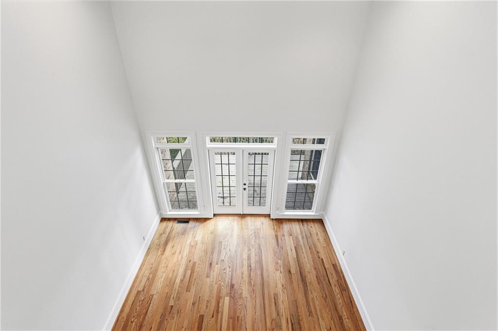 125 River N Circle Sandy Springs, GA 30328 - Photo 58 of 96 a view of an empty room with wooden floor and a window