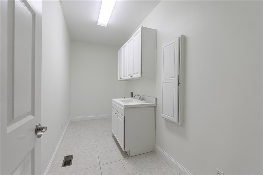 125 River N Circle Sandy Springs, GA 30328 - Photo 75 of 96 a utility room with cabinets washer and dryer