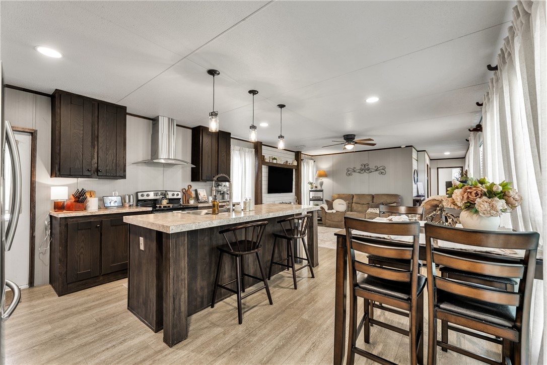 a kitchen with kitchen island a sink stove and refrigerator
