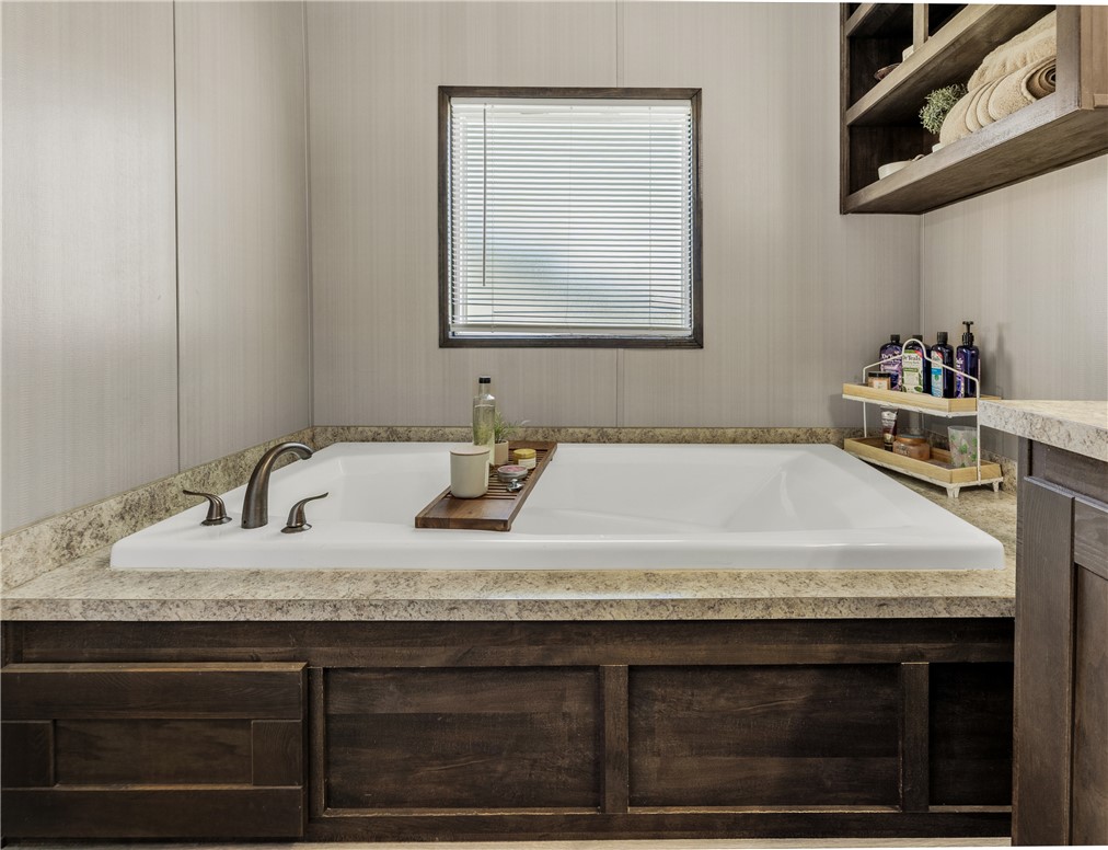 3133 Henderson Road Navasota, TX 77868 - Photo 16 of 26 a bathroom with a granite countertop sink and a mirror