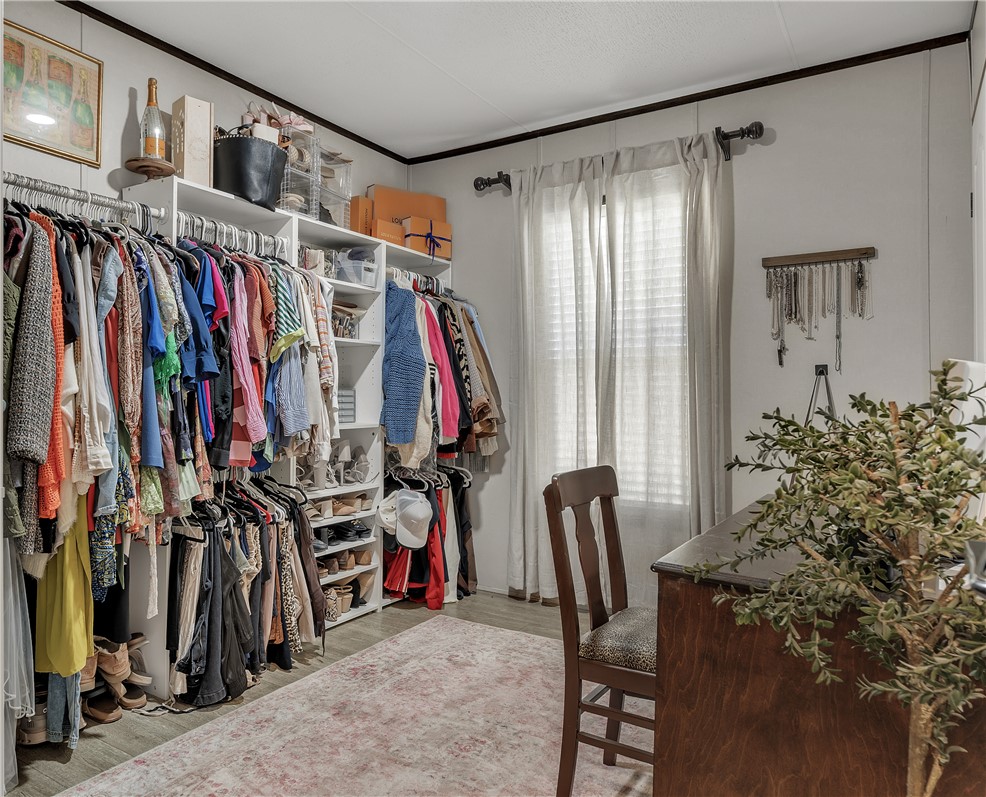 3133 Henderson Road Navasota, TX 77868 - Photo 22 of 26 a view of walk in closet with clothes