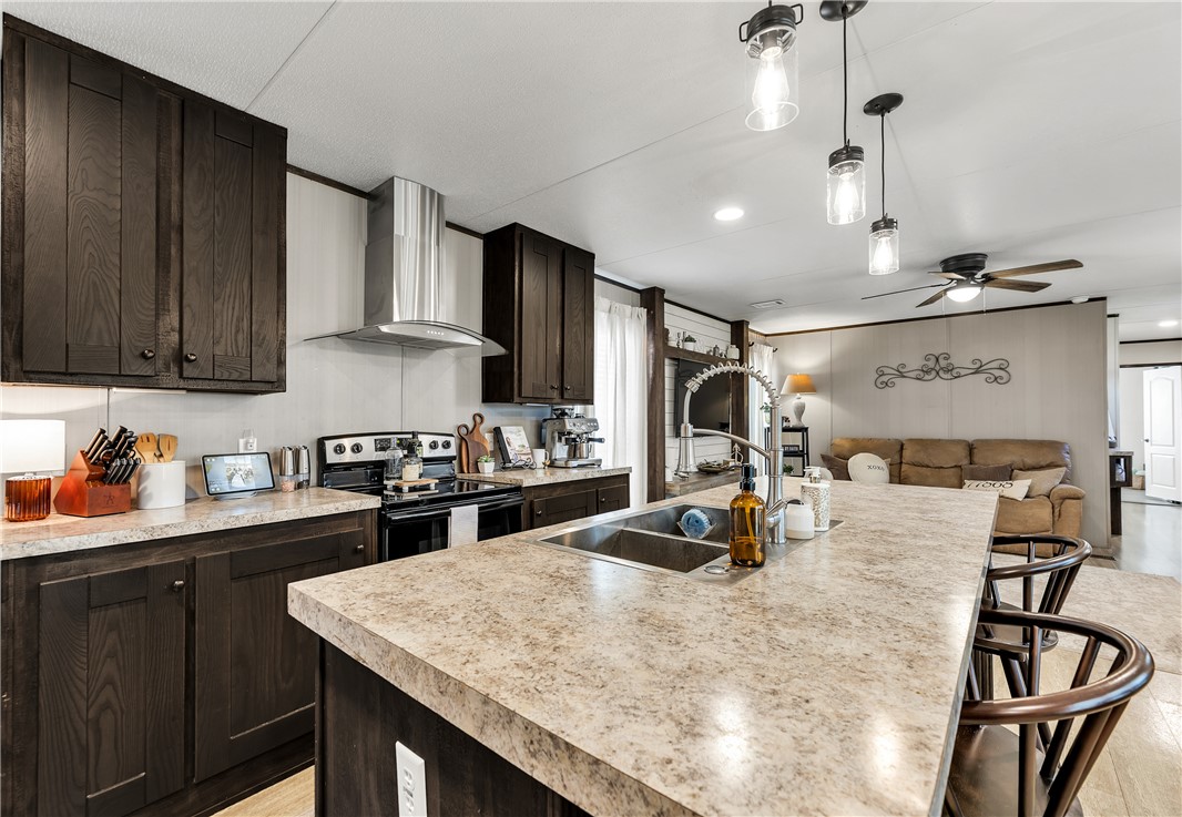 3133 Henderson Road Navasota, TX 77868 - Photo 6 of 26 a kitchen with kitchen island granite countertop a sink appliances and cabinets