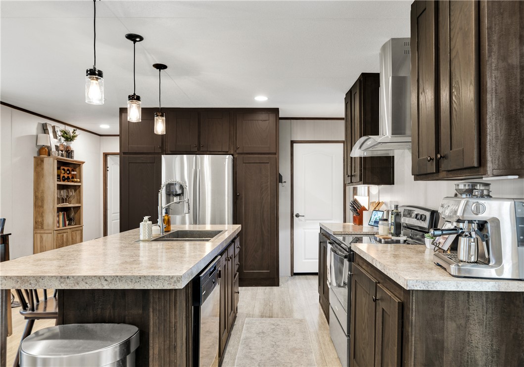 3133 Henderson Road Navasota, TX 77868 - Photo 9 of 26 a kitchen with stainless steel appliances granite countertop a sink refrigerator and cabinets