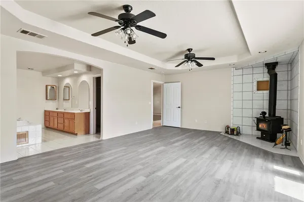 a view of a livingroom with wooden floor and a ceiling fan