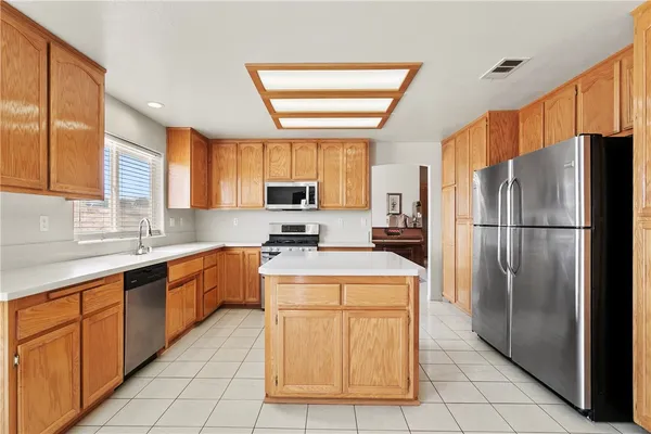 a kitchen with stainless steel appliances granite countertop a refrigerator sink stove microwave and cabinets